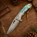 Wolf Engraved Damascus-Pattern Folding Knife with Iridescent Shell Handle & Leather Lanyard